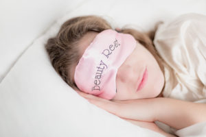 Woman resting in bed with eyemask